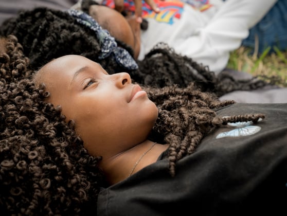 Image of two girls laying on the grass, representing understanding the treatment journey